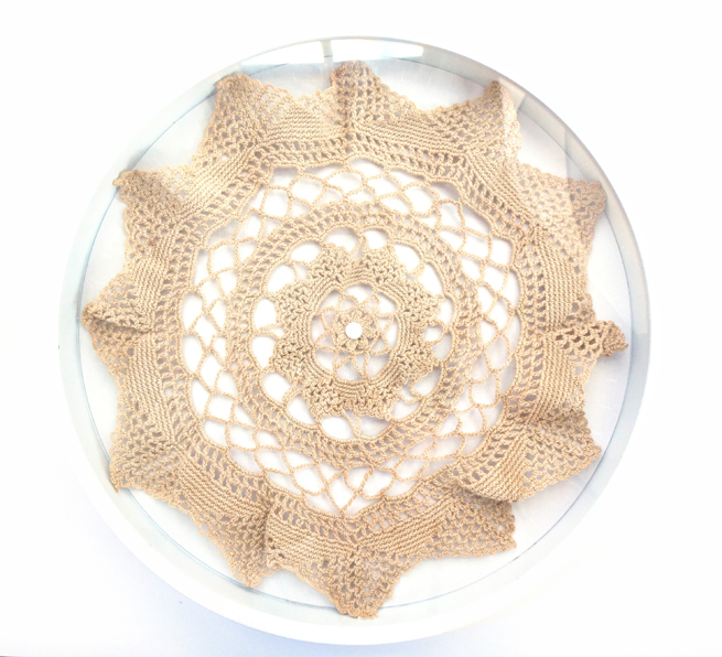 image, antique doily framed in repurposed round clock frame